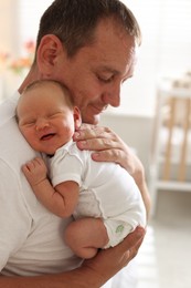 Photo of Father with his newborn baby at home