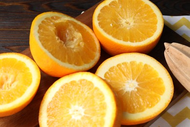 Photo of Squeezed oranges and juicer on table, closeup. Making fresh juice