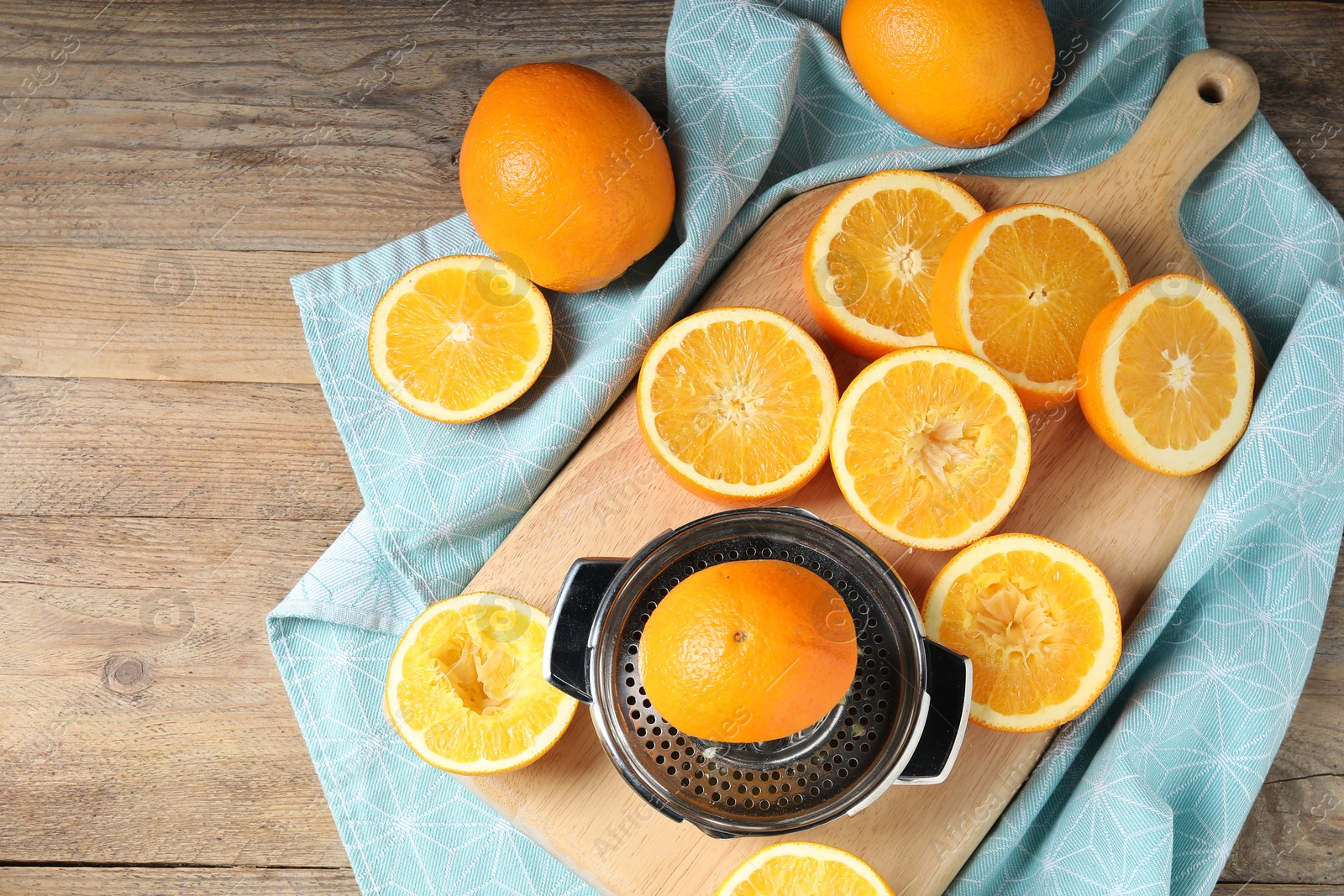 Squeezer and oranges on wooden table, flat lay. Making fresh juice Photo of Squeezer and oranges on wooden table, flat lay. Making fresh juice
