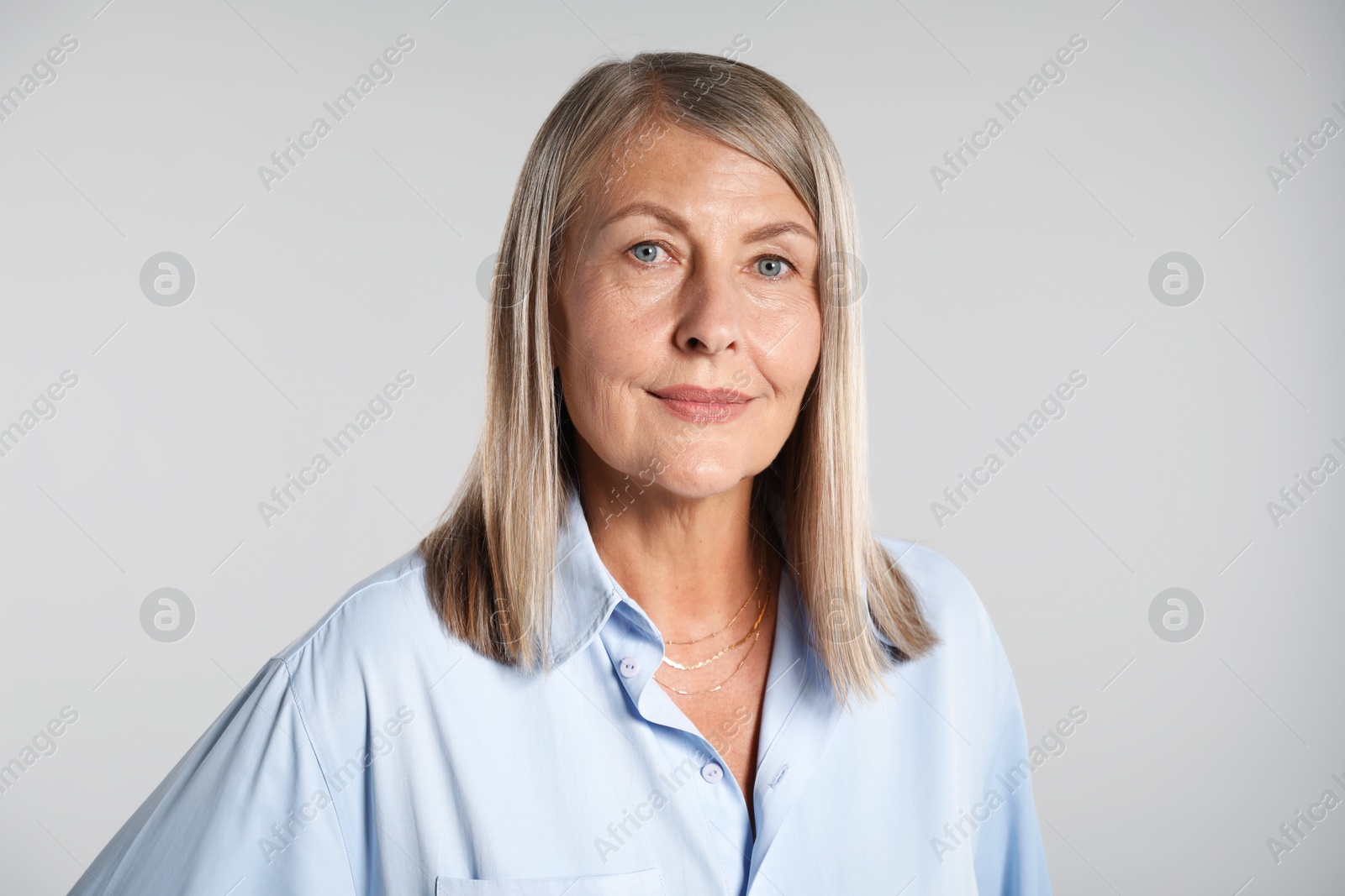 Photo of Portrait of beautiful senior woman on light background