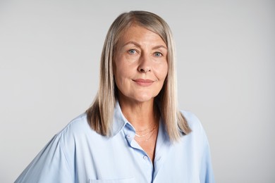 Photo of Portrait of beautiful senior woman on light background