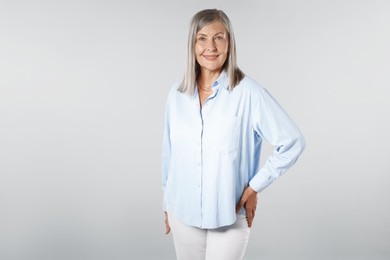 Photo of Portrait of beautiful senior woman on light background. Space for text