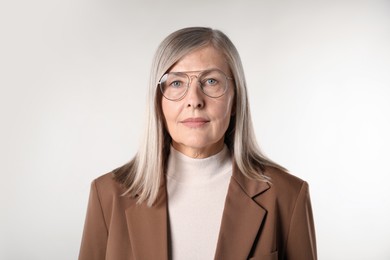 Photo of Portrait of beautiful senior woman on light background