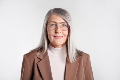 Photo of Portrait of beautiful senior woman on light background