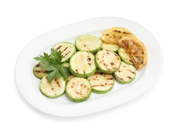 Photo of Delicious grilled courgette slices with lemon and parsley isolated on white, above view