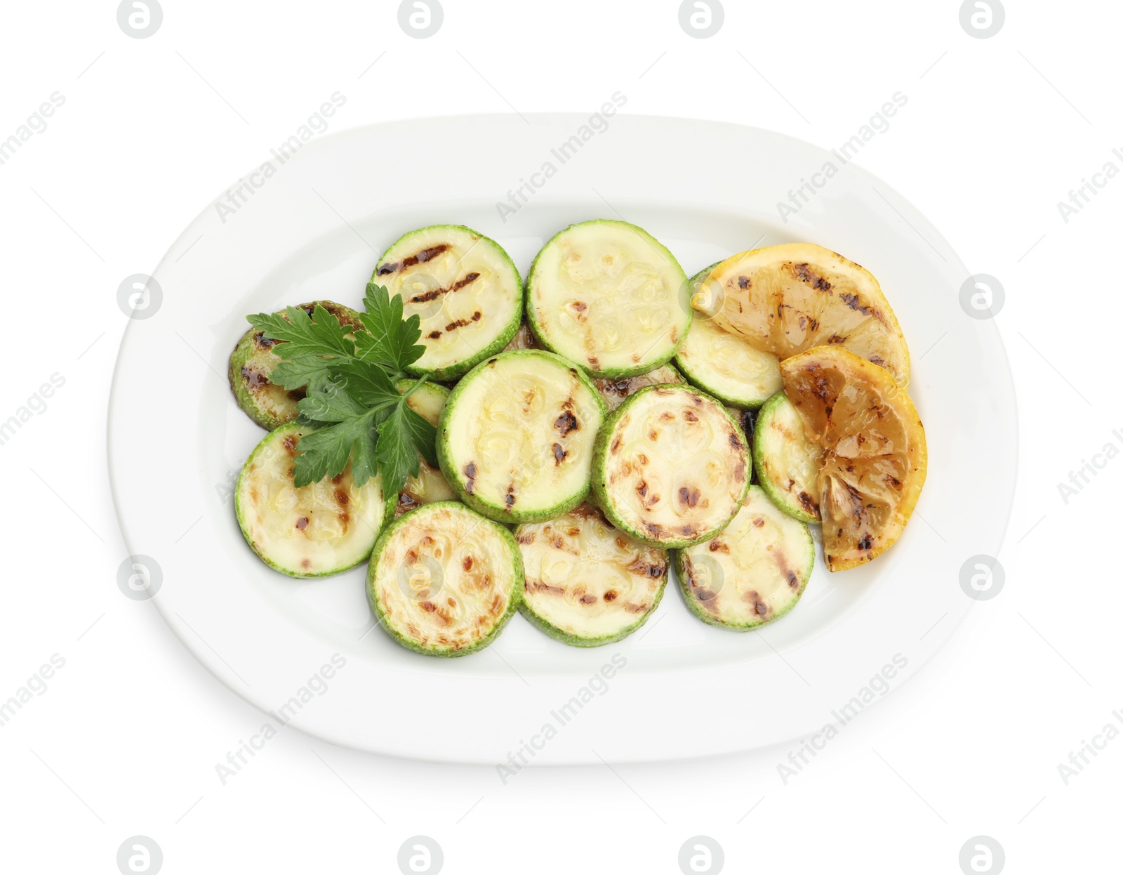 Delicious grilled courgette slices with lemon and parsley isolated on white, top view Photo of Delicious grilled courgette slices with lemon and parsley isolated on white, top view