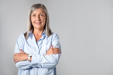 Photo of Portrait of beautiful senior woman on light background. Space for text