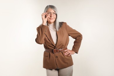 Photo of Portrait of beautiful senior woman on light background