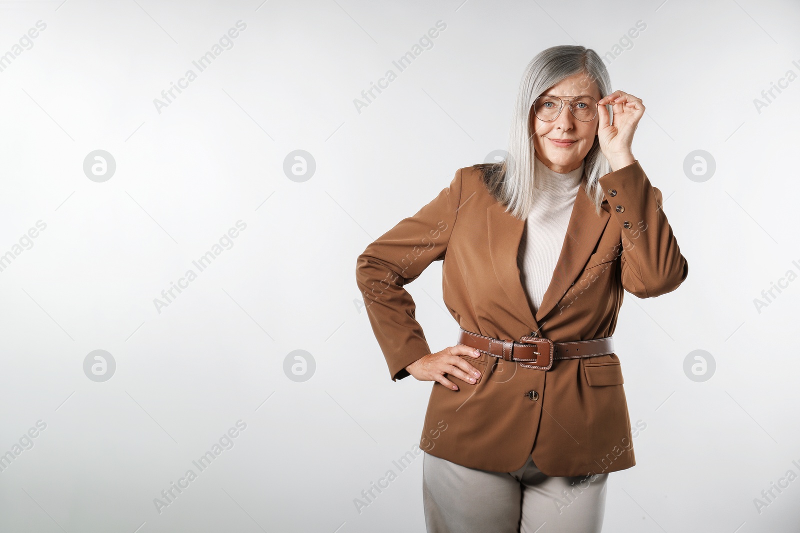 Photo of Portrait of beautiful senior woman on light background. Space for text