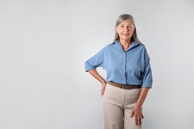 Photo of Portrait of beautiful senior woman on white background. Space for text