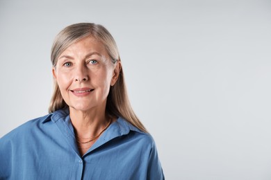 Photo of Portrait of beautiful senior woman on white background. Space for text