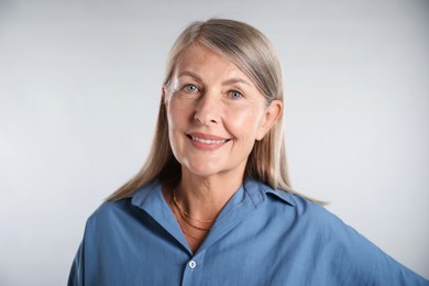 Photo of Portrait of beautiful senior woman on white background