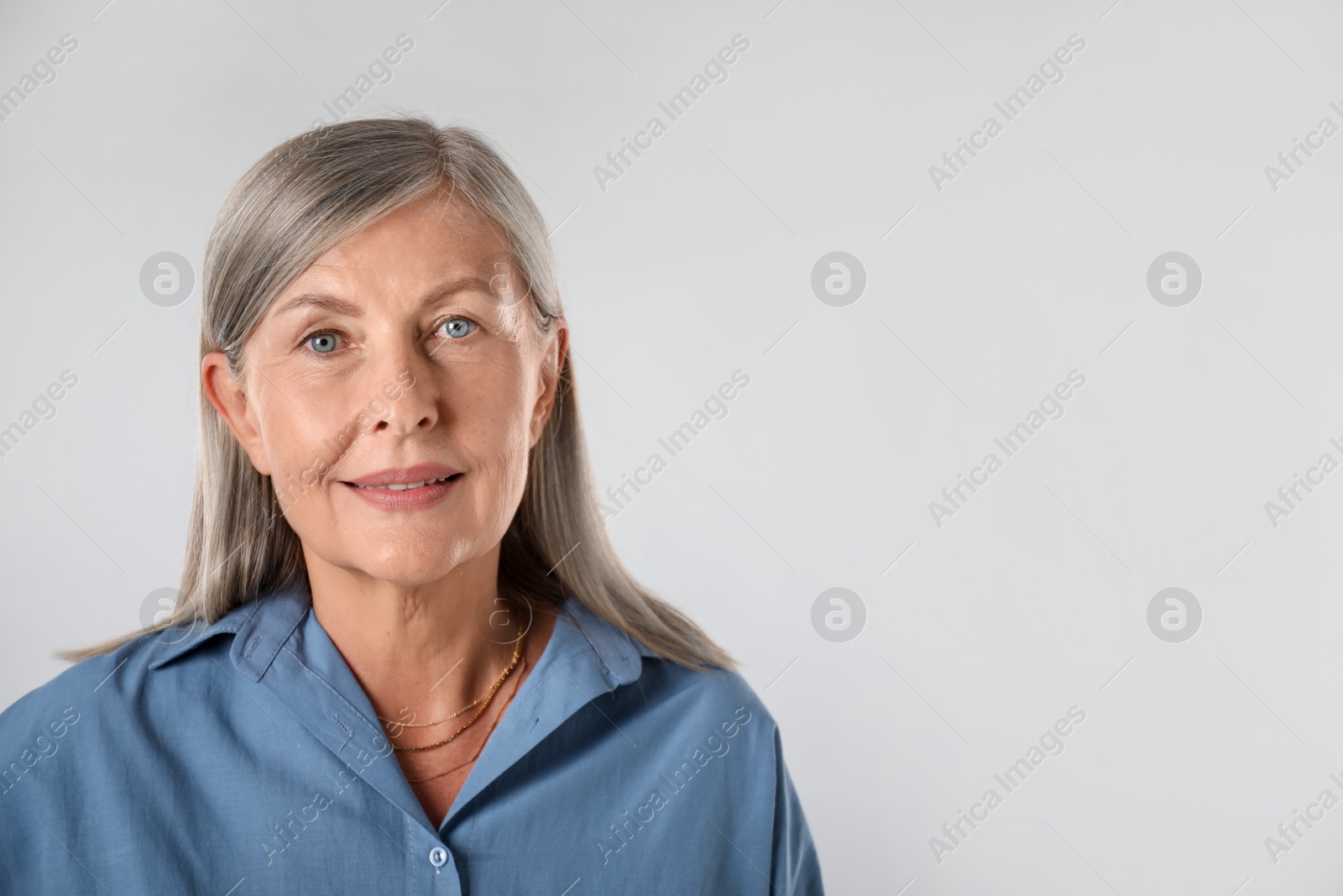 Photo of Portrait of beautiful senior woman on white background. Space for text