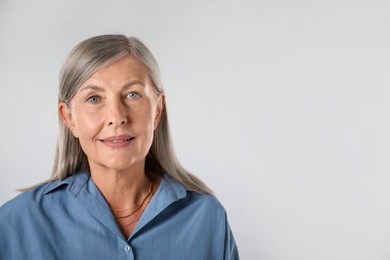 Photo of Portrait of beautiful senior woman on white background. Space for text