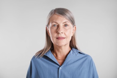 Photo of Portrait of beautiful senior woman on white background