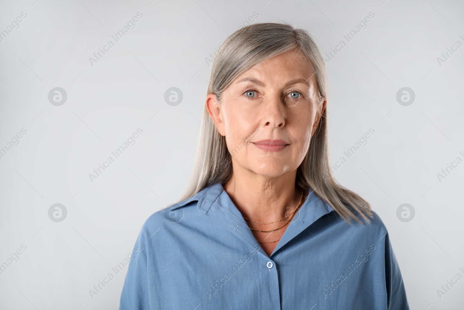 Photo of Portrait of beautiful senior woman on white background. Space for text