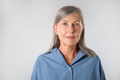 Photo of Portrait of beautiful senior woman on white background. Space for text