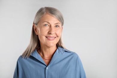 Photo of Portrait of beautiful senior woman on white background. Space for text