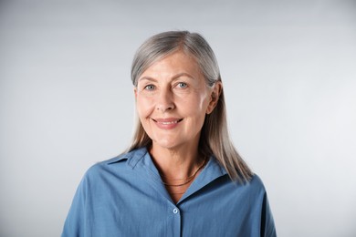 Photo of Portrait of beautiful senior woman on white background