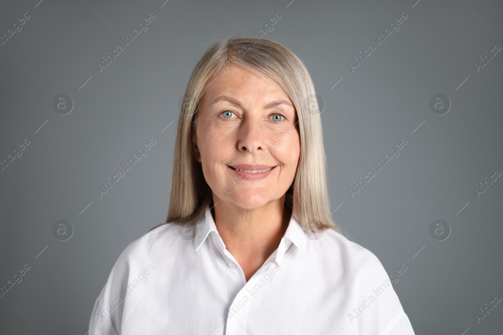 Photo of Portrait of beautiful senior woman on grey background