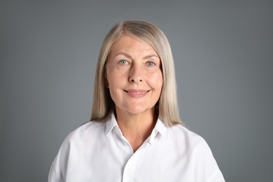 Photo of Portrait of beautiful senior woman on grey background