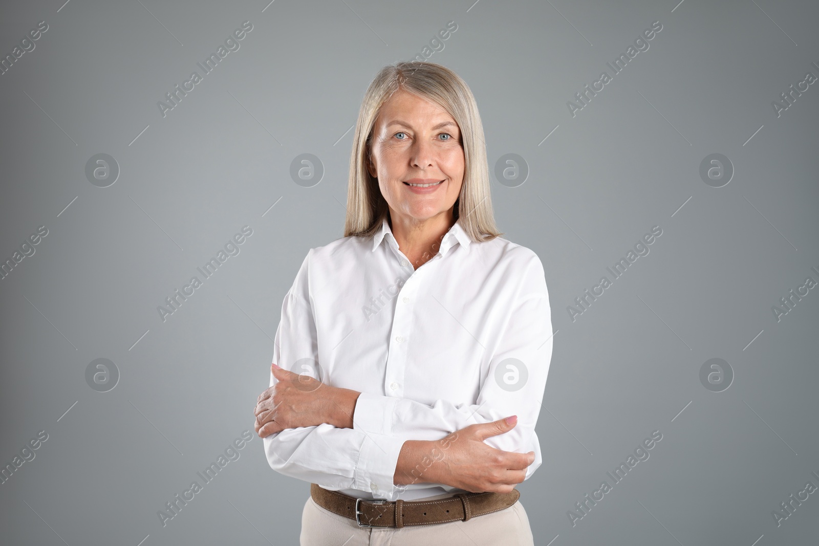Portrait of beautiful senior woman on grey background Photo of Portrait of beautiful senior woman on grey background