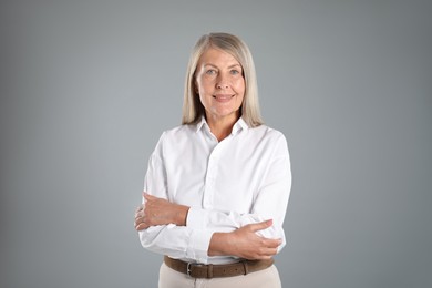 Photo of Portrait of beautiful senior woman on grey background