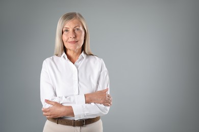Photo of Portrait of beautiful senior woman on grey background. Space for text