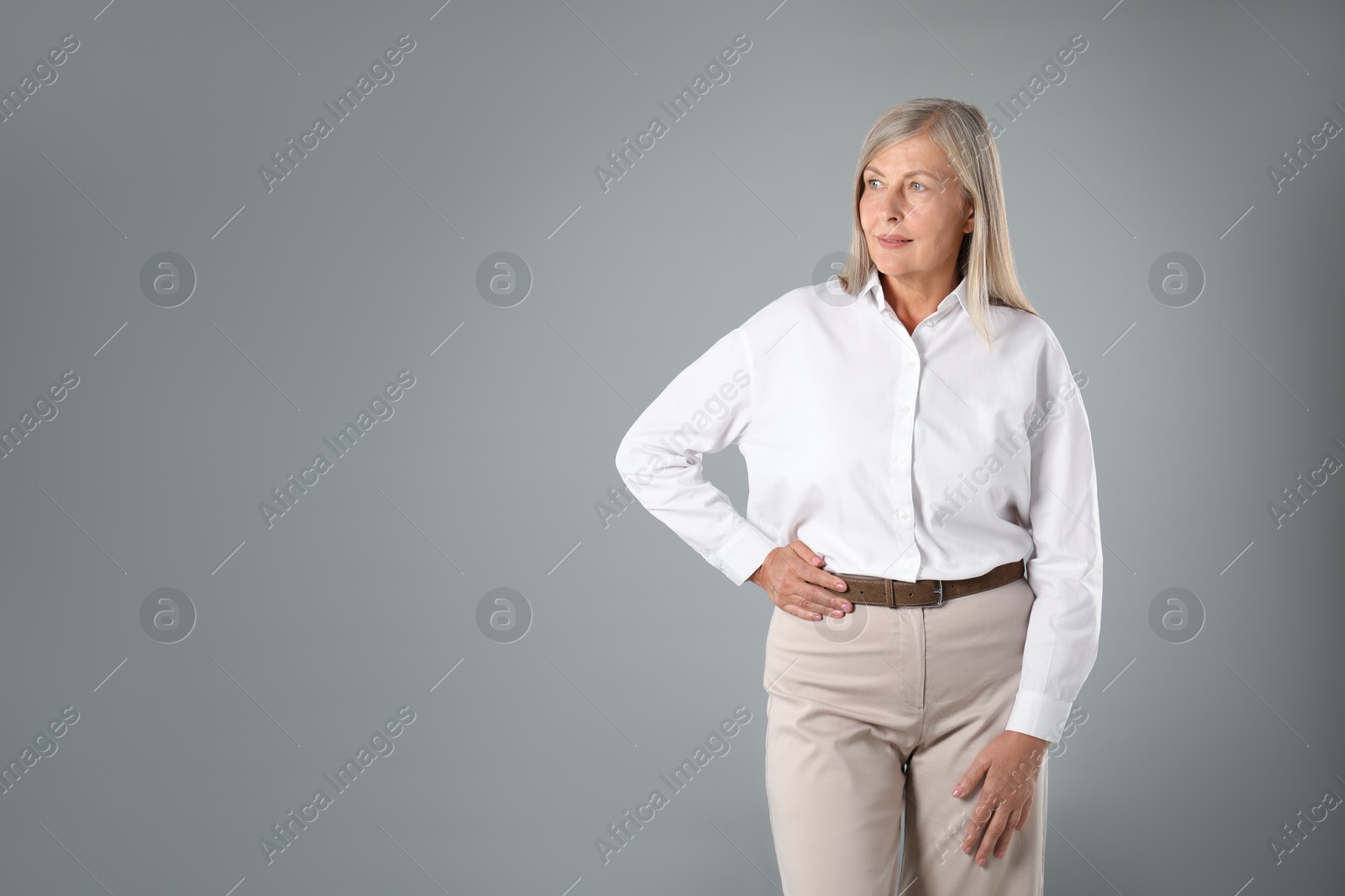 Photo of Portrait of beautiful senior woman on grey background. Space for text