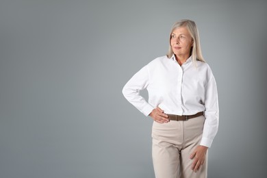 Photo of Portrait of beautiful senior woman on grey background. Space for text