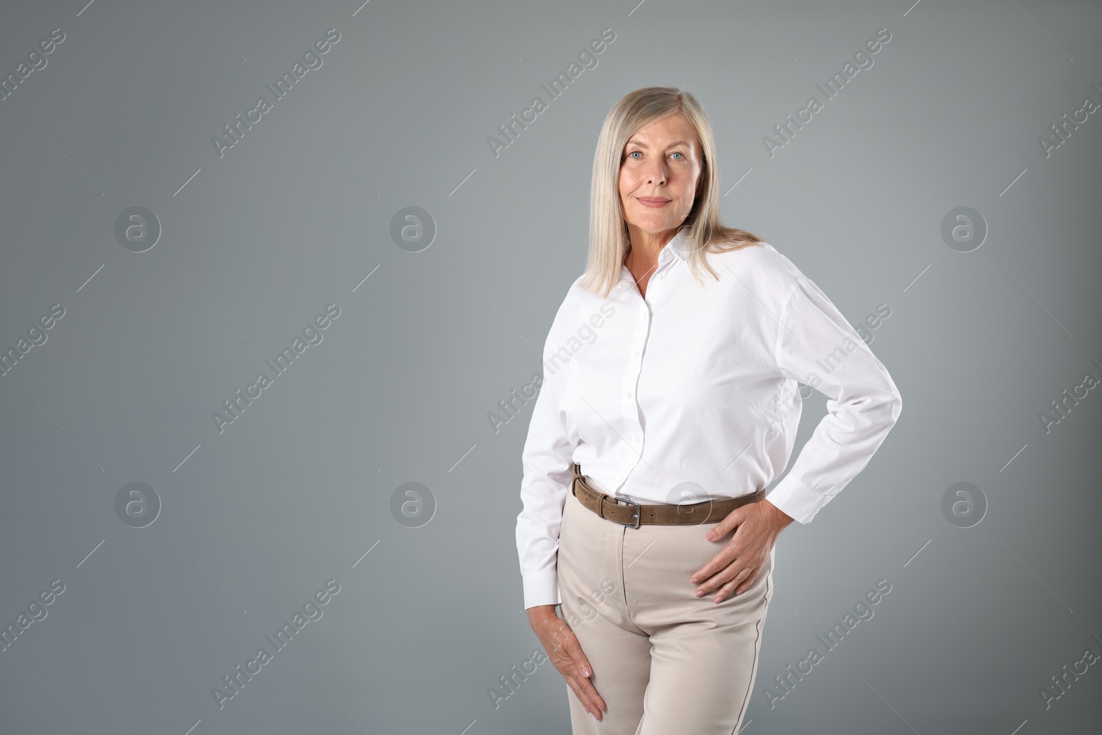 Photo of Portrait of beautiful senior woman on grey background. Space for text