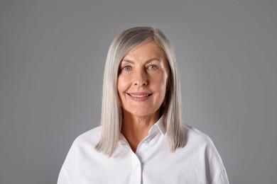 Photo of Portrait of beautiful senior woman on grey background