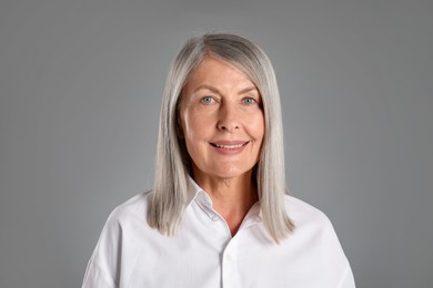 Photo of Portrait of beautiful senior woman on grey background