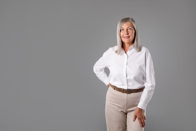 Photo of Portrait of beautiful senior woman on grey background. Space for text