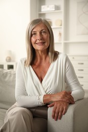 Photo of Elegant senior woman on sofa at home