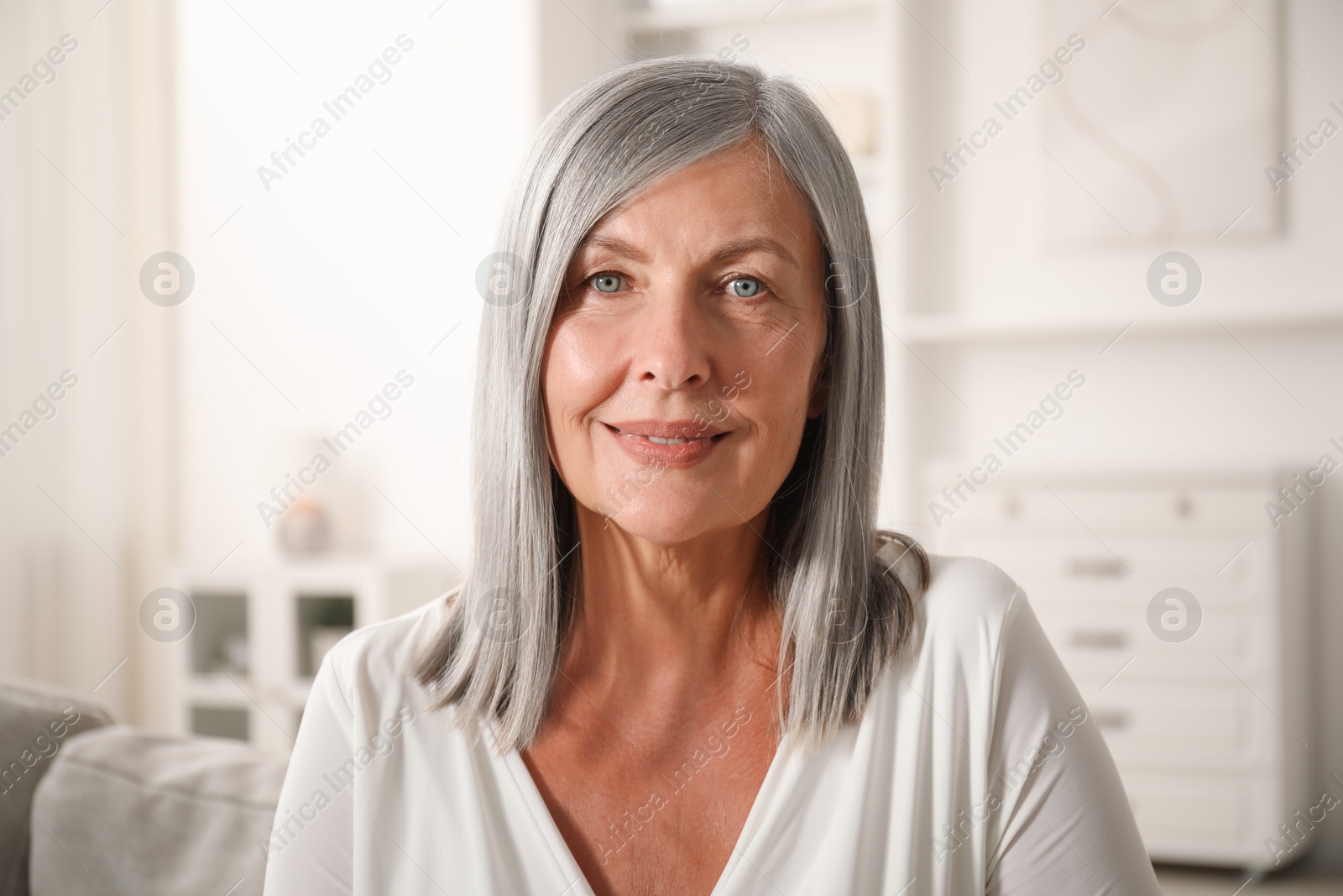 Photo of Elegant senior woman on sofa at home