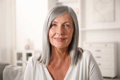 Photo of Elegant senior woman on sofa at home