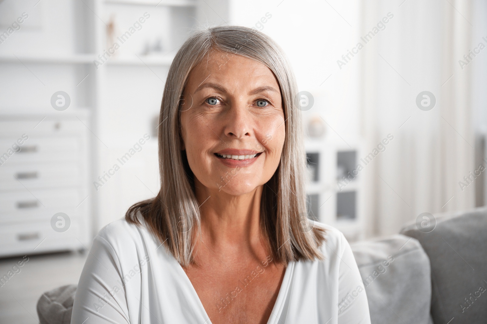 Photo of Elegant senior woman on sofa at home