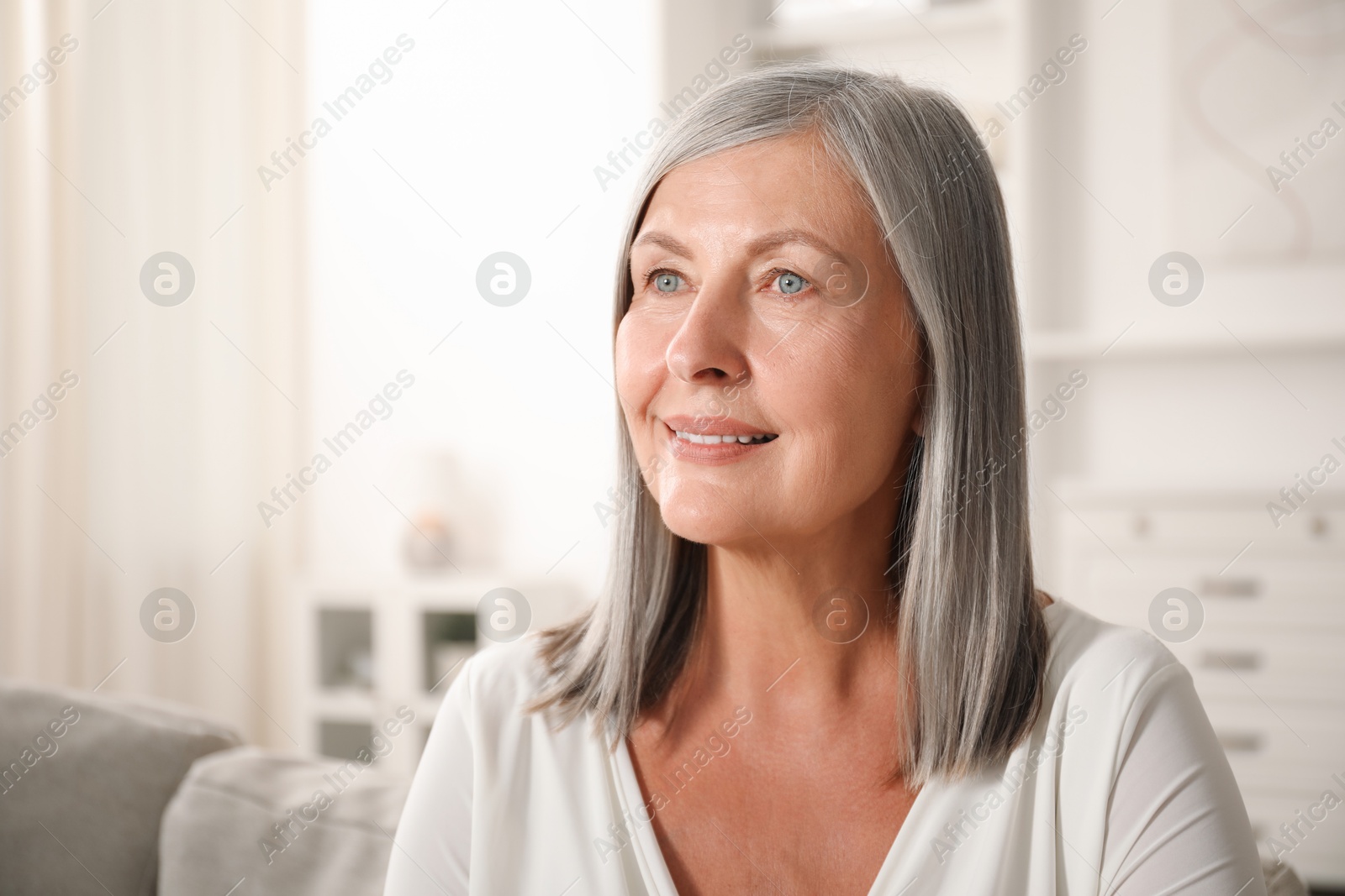 Photo of Elegant senior woman on sofa at home