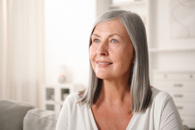 Photo of Elegant senior woman on sofa at home