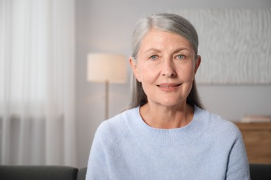 Photo of Elegant senior woman at home. Space for text