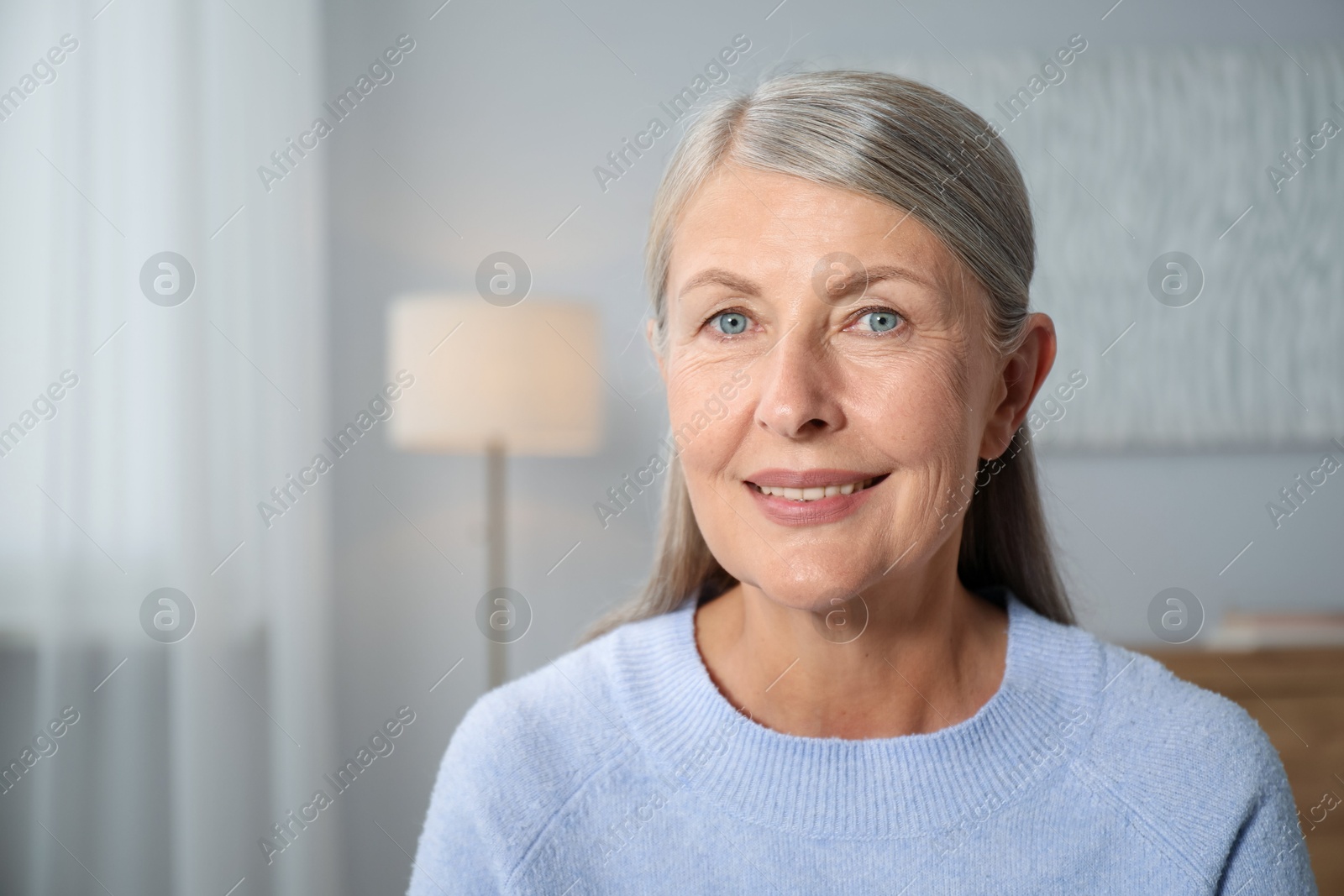 Photo of Elegant senior woman at home. Space for text