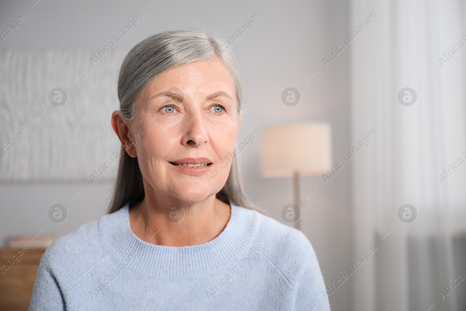 Photo of Elegant senior woman at home. Space for text