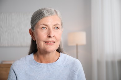 Photo of Elegant senior woman at home. Space for text