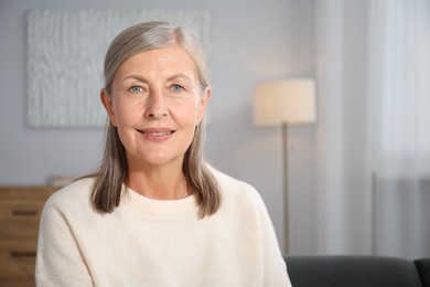 Photo of Elegant senior woman at home. Space for text