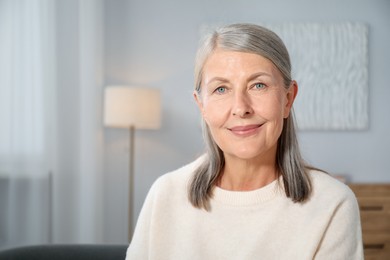Photo of Elegant senior woman at home. Space for text