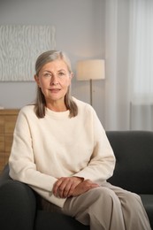 Photo of Elegant senior woman on sofa at home