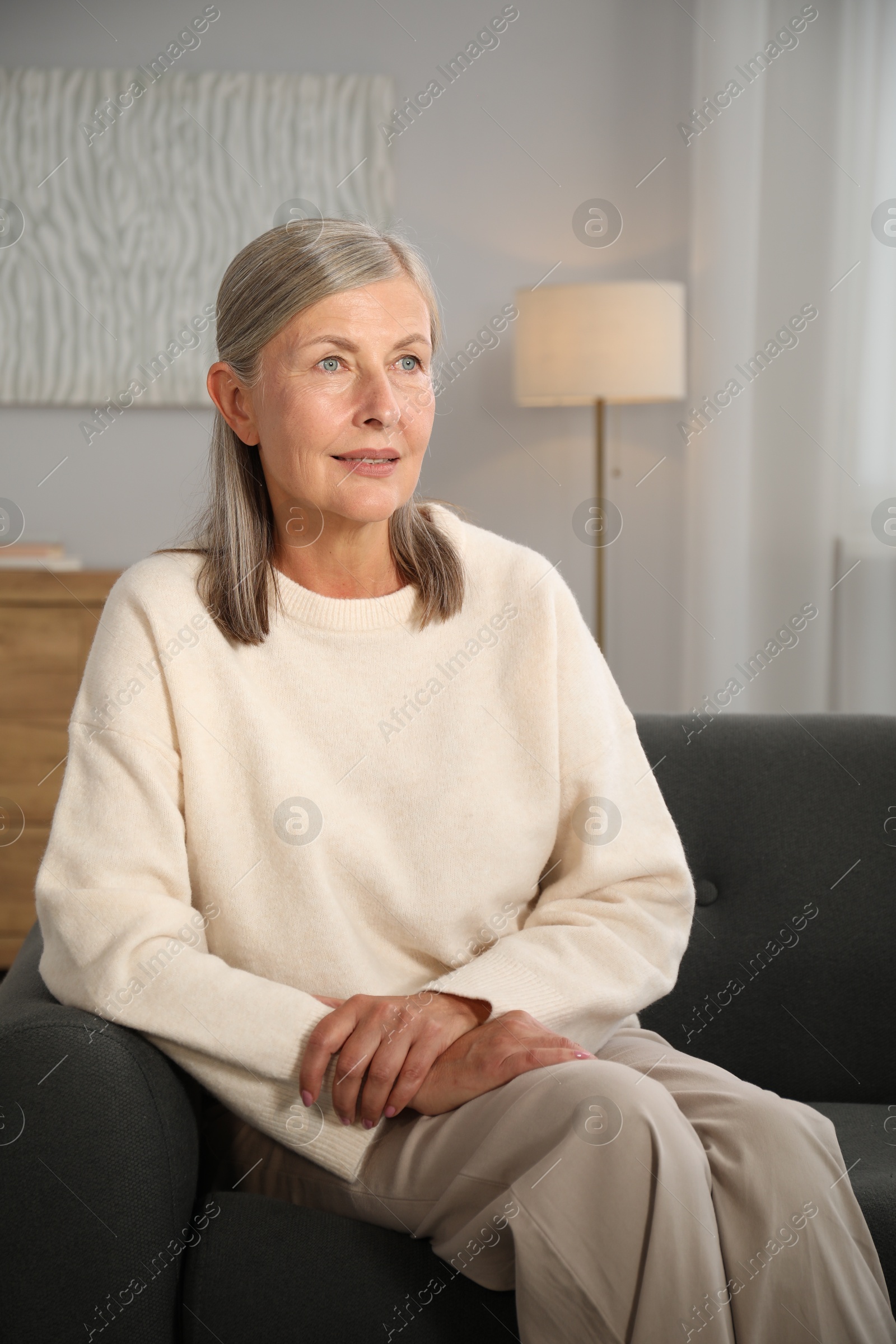 Photo of Elegant senior woman on sofa at home