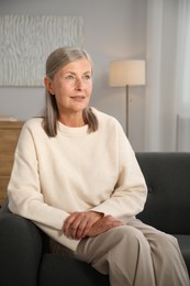 Photo of Elegant senior woman on sofa at home