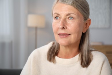 Photo of Elegant senior woman at home. Space for text